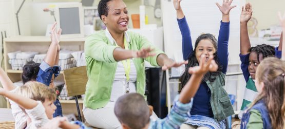 Teacher leading a movement break in the classroom with young kids